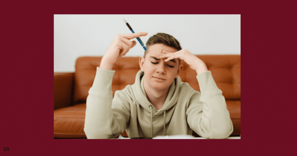 an image showing a guy frustrated with a pencil in hand 