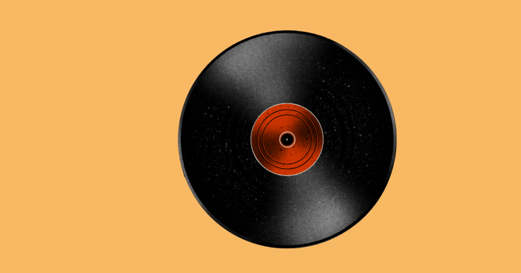 "Black vinyl record with an orange center label on a light orange background."